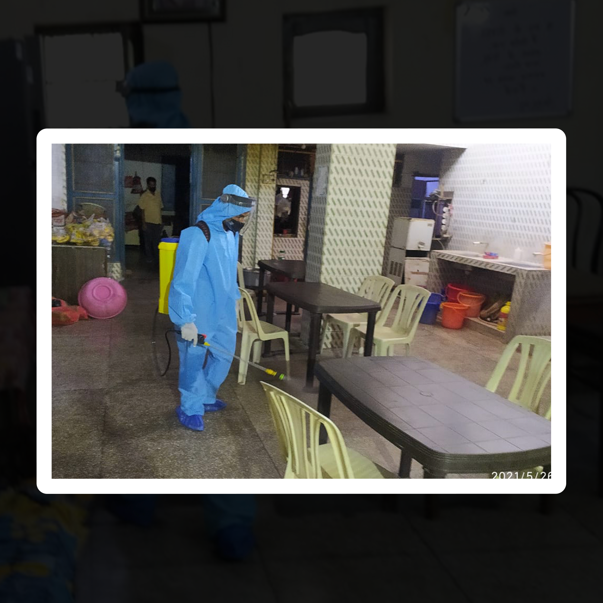 A man spray senitizer on floor